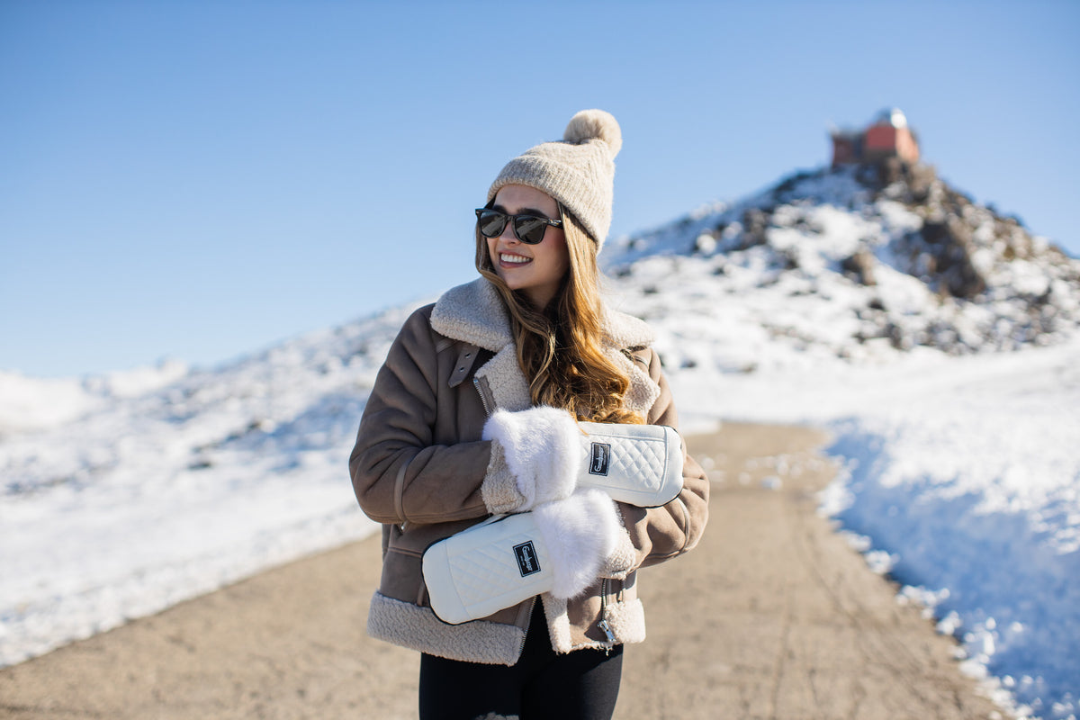 White Emmaljunga winter gloves worn during a winter walk